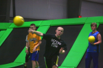 Boy Throwing Dodgeball with Teammates